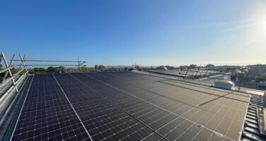 Solar Panel System on the roof of Jacksons Workwear with a view of Lincoln cathedral in the background
