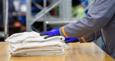 Folded workwear on a table being piled up