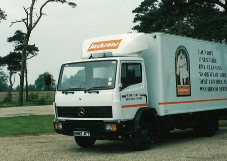 A white and orange Jacksons van